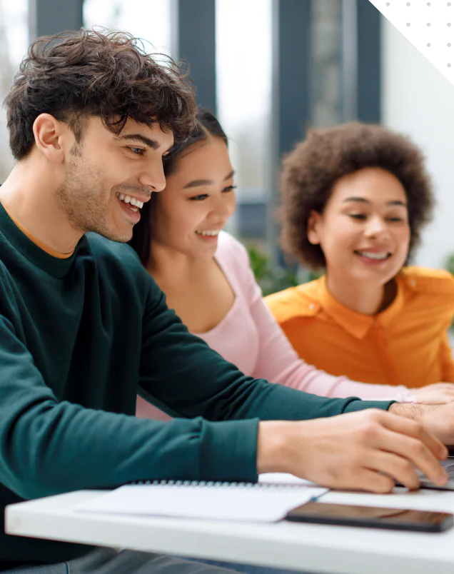 Three students collaborating on a laptop